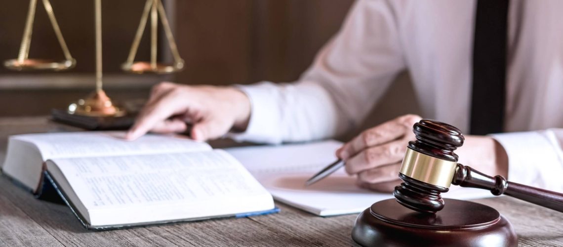 male-lawyer-or-judge-working-with-law-books-1.jpg